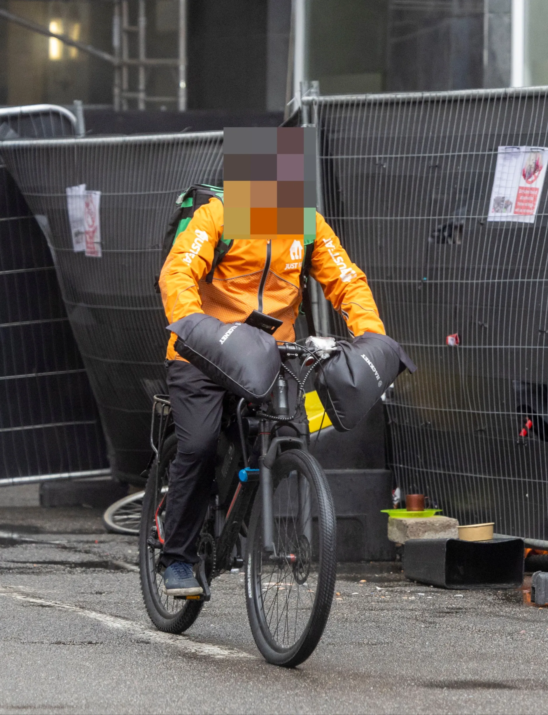 Delivery rider with censored face showing illegal work practices